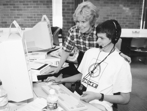 Sheryl Burgstahler helps a Scholar at the computer in the computer lab. Photo of Sheryl Burgstahler helps a Scholar at the computer in the computer lab.