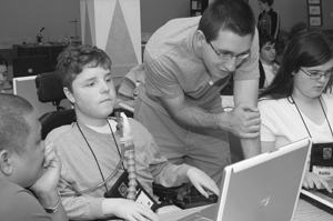 Photo of DO-IT Mentor assisting a DO-IT Scholar on the computer.