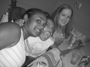 Three DO-IT Scholars engaged in a group hug while smiling. Photo of three DO-IT Scholars engaged in a group hug while smiling.