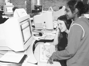 Two DO-IT Scholars collaborate at a computer to problem solve. Photo of two DO-IT Scholars collaborate at a computer to problem solve.