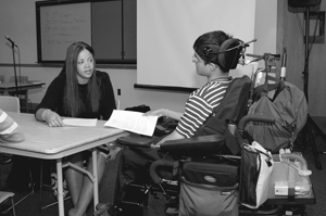 Photo of two DO-IT Scholars talk through an assignment in a classroom.