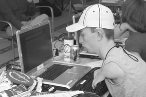 Photo of DO-IT Scholar working on an email on a lap top in the computer lab.