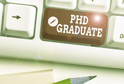 The phrase "PHD Graduate" on a keyboard key. The phrase "PHD Graduate" on a keyboard key.