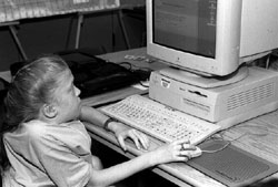Amanda sits at a computer Photo of Amanda sitting at a computer