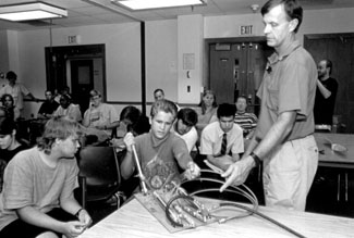 Photo of DO-IT Intern Jessie and DO-IT Scholar Justin participate in a class activity