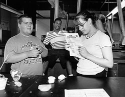 Photo of DO-IT Scholars Abe, Arnell and Crystal in the lab