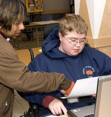 Two students working on a computer.
