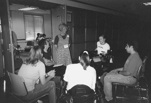 DO-IT Director Sheryl Burgstahler with Phase II DO-IT Scholars in a circle.