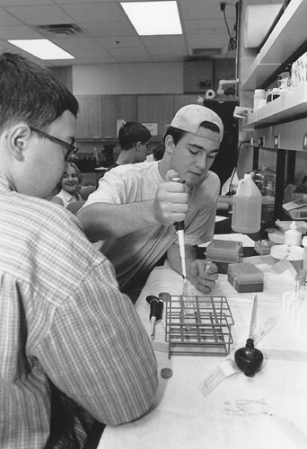 Picture of Michael and Todd at a lab table performing an experiment.