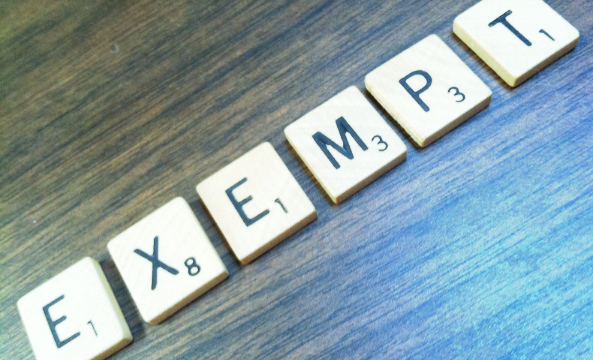 the word "exempt" spelled out in scrabble tiles