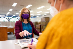 A librarian directs a patron