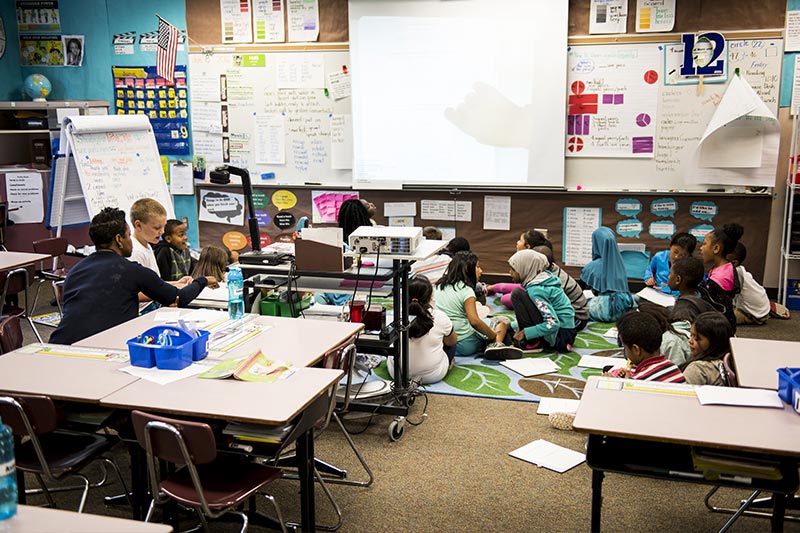 Using the overhead projector, Brown leads her students through a math lesson