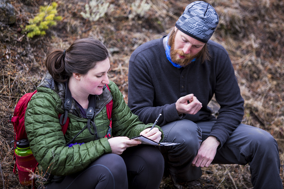 Zach Gregory, ’15, a wildlife technician working alongside Koitzsch, shows Jenny Brent, ’19, how to enter data on a necropsy form. Gregory took this class as an undergraduate.