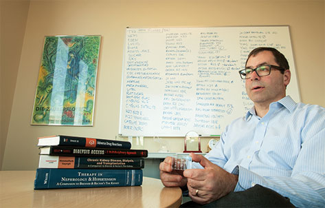 Team member Jonathan Himmelfarb, M.D., holds an early prototype of kidney-on-a-chip.